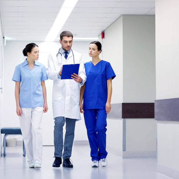 group-of-medics-at-hospital-with-clipboard-PVUWFHV.png Experienced dental team providing patient care